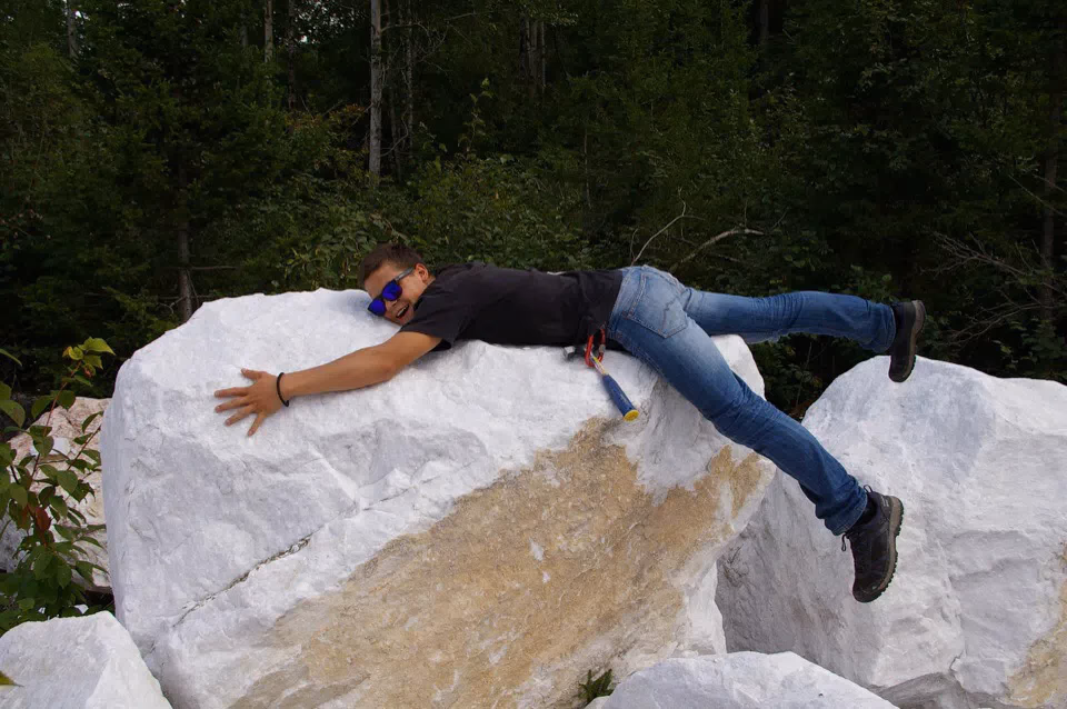Gemologist at the Slyudyanka lavrovite deposit, marble outcrop, Lake Baikal, Russia