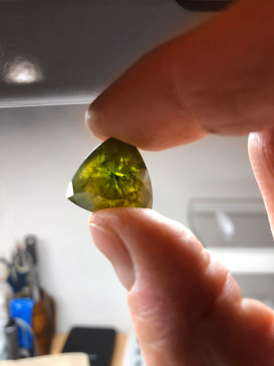 Trillion-cut Russian demantoid of nearly 30 carats, filled with horsetail inclusions